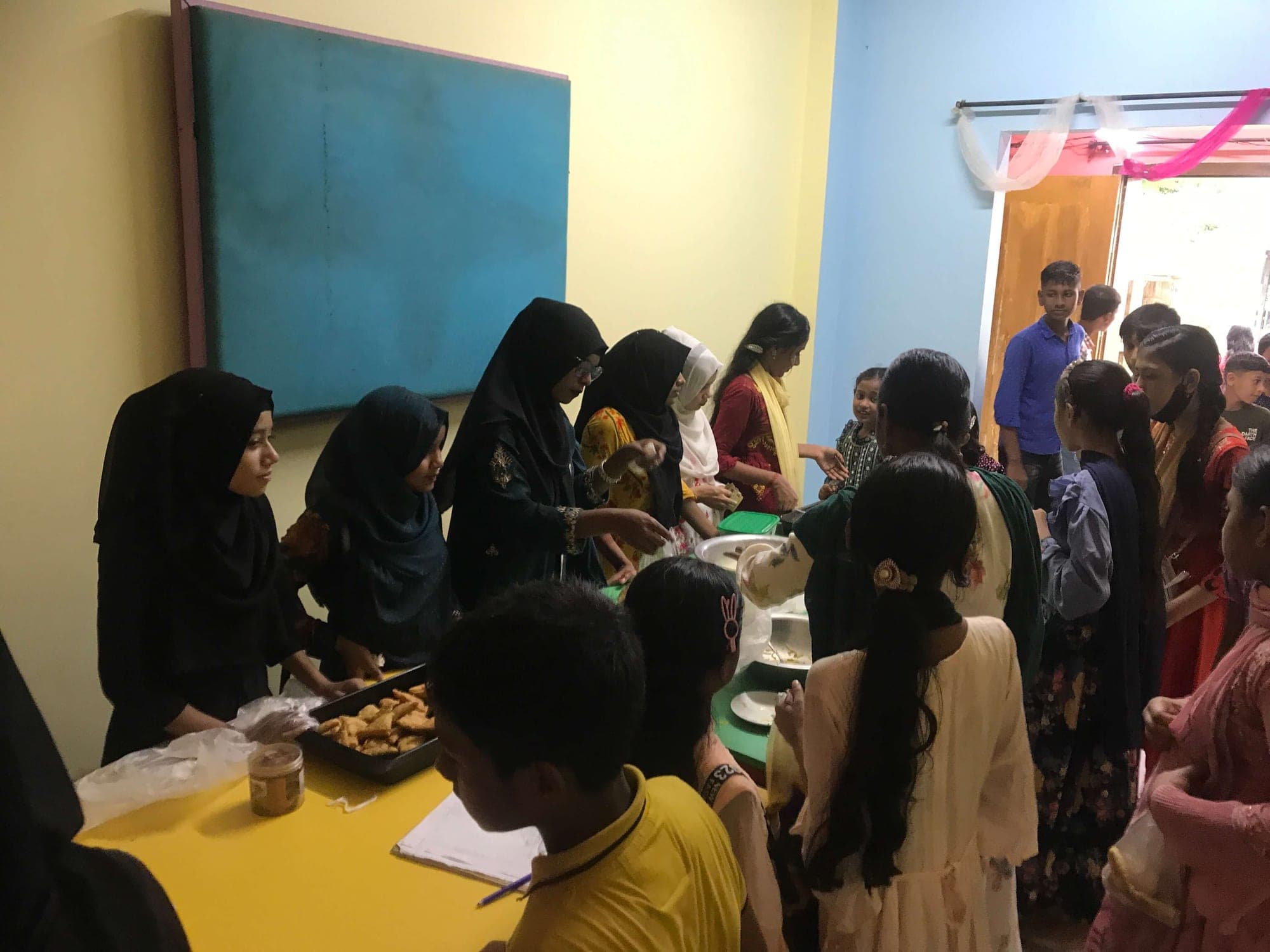 Cooking students serving food at a community event